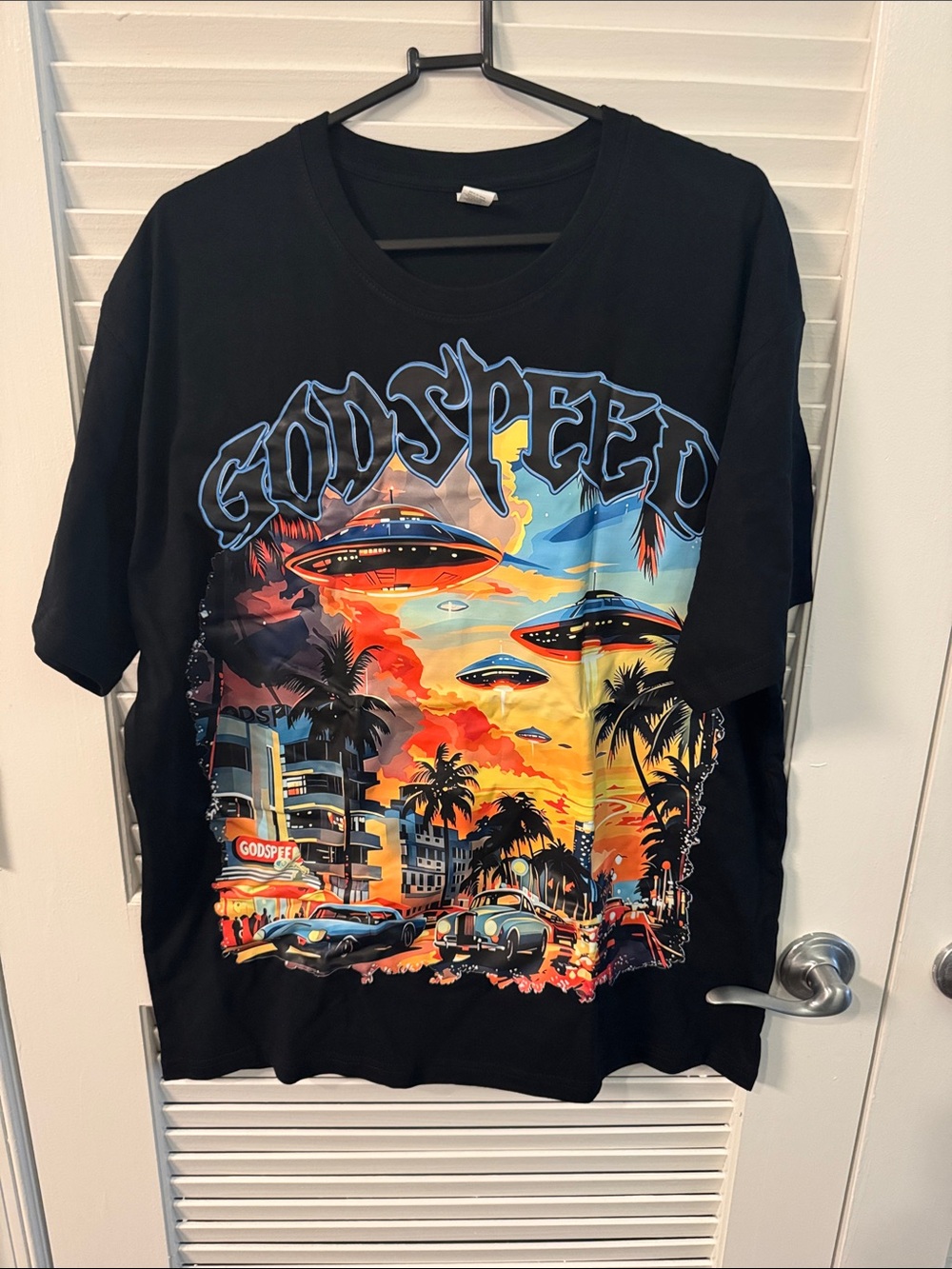 Godspeed Miami UFO t-shirt features a colorful graphic of retro flying saucers
